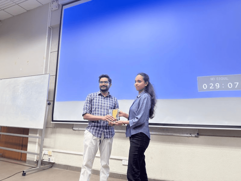 Receiving a token of appreciation from the faculty